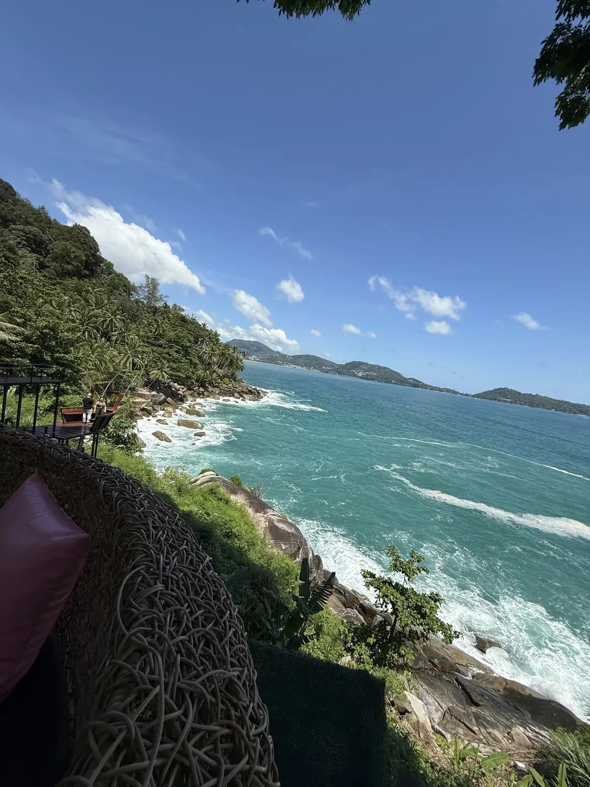 Route en corniche surplombant la mer et une presqu'île boisée, sur la côte ouest de Phuket